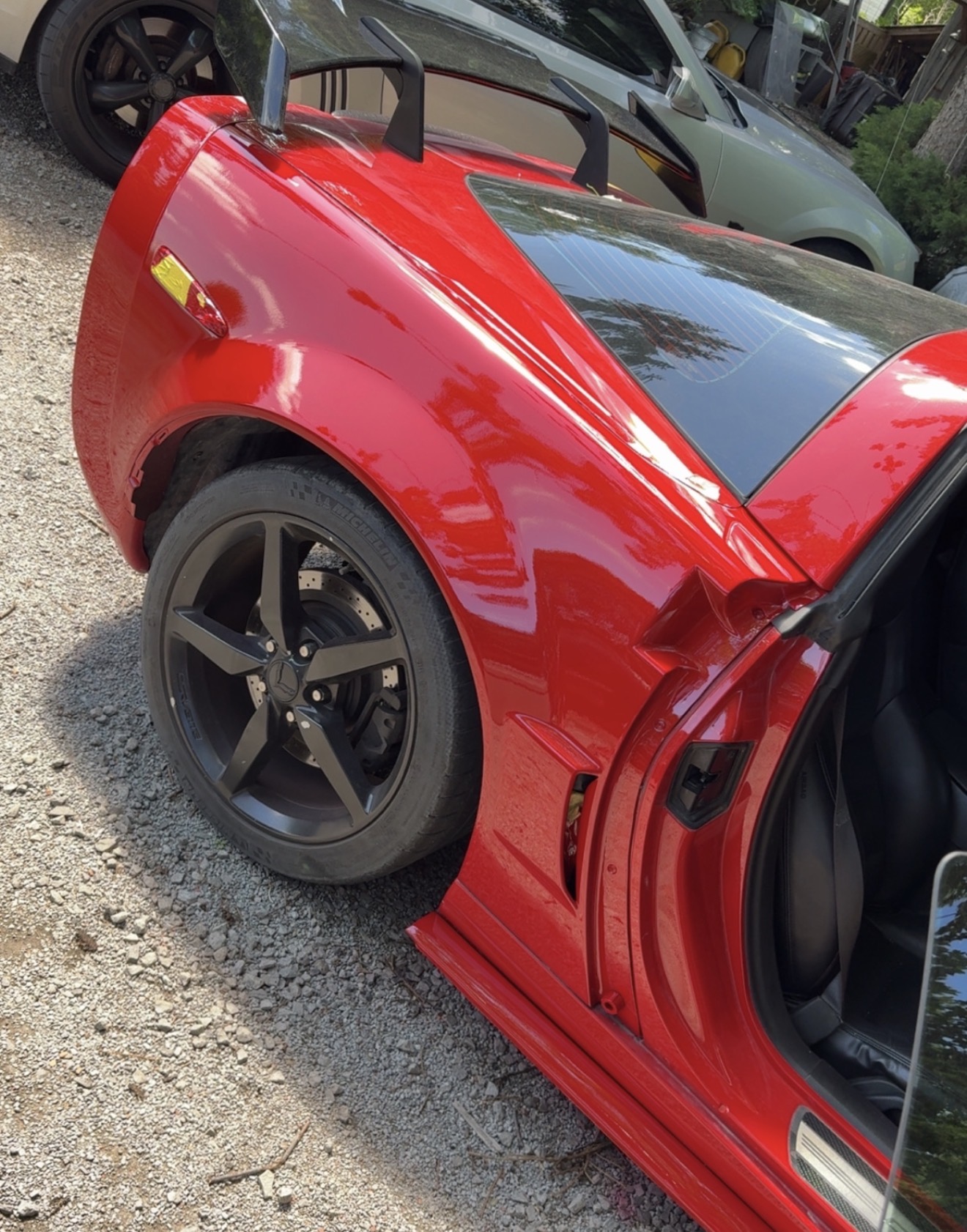 Finished red Corvette fender after colour matching and refinishing